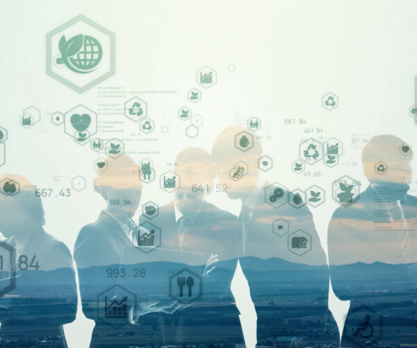 Silhouettes of people in business attire overlaid with environmental icons and data, representing sustainability and collaboration.