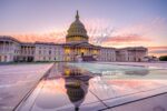 The image depicts the United States Capitol building at sunrise, with a reflection in a nearby pool. The sky is filled with pink and orange clouds.