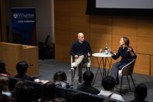 Turner Speaker Series Gregg Renfrew 2 Bobby Turner and Greg Renfrew chatting, sitting in white chairs around a white round table in a fireside chat style program
