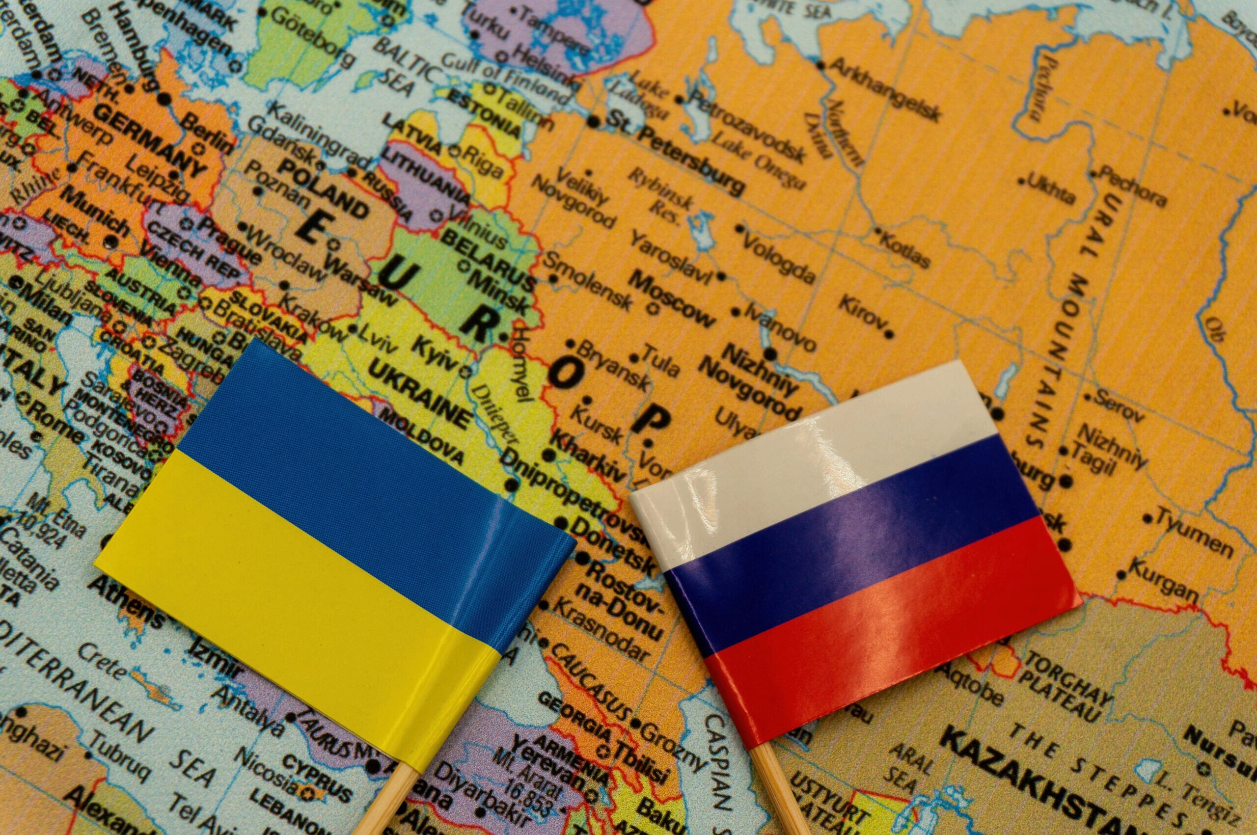The Ukrainian and Russian flags are placed on a map of Europe