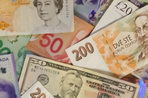 Global Climate Finance A collection of international banknotes, including British pounds, Czech koruna, Canadian dollars, U.S. dollars, and more, representing global currency diversity.
