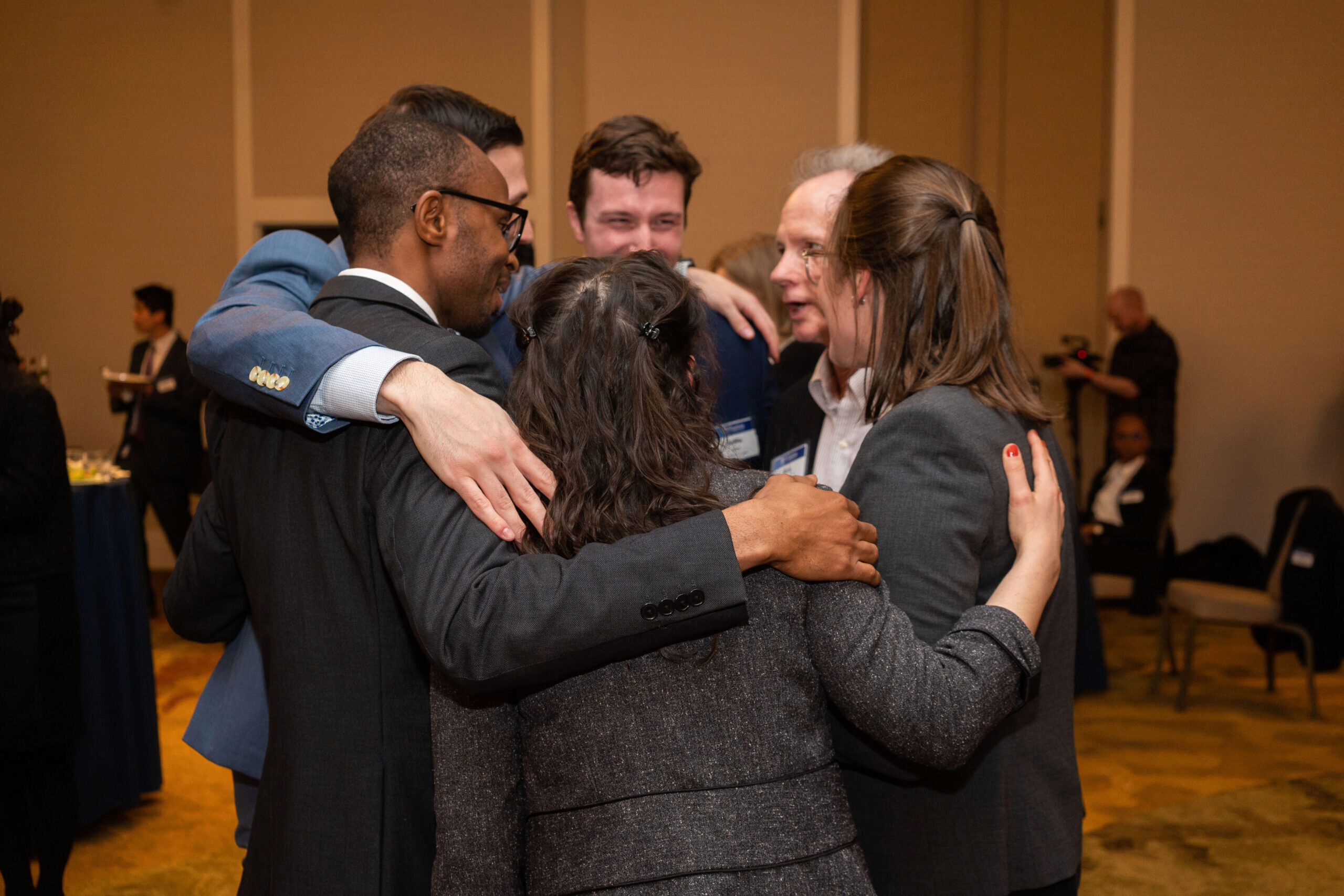 TMIINT team pictured in a group hug after learning they will be advancing to the finals.