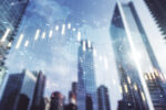 Decorative image of abstract financial graph with world map on office buildings background