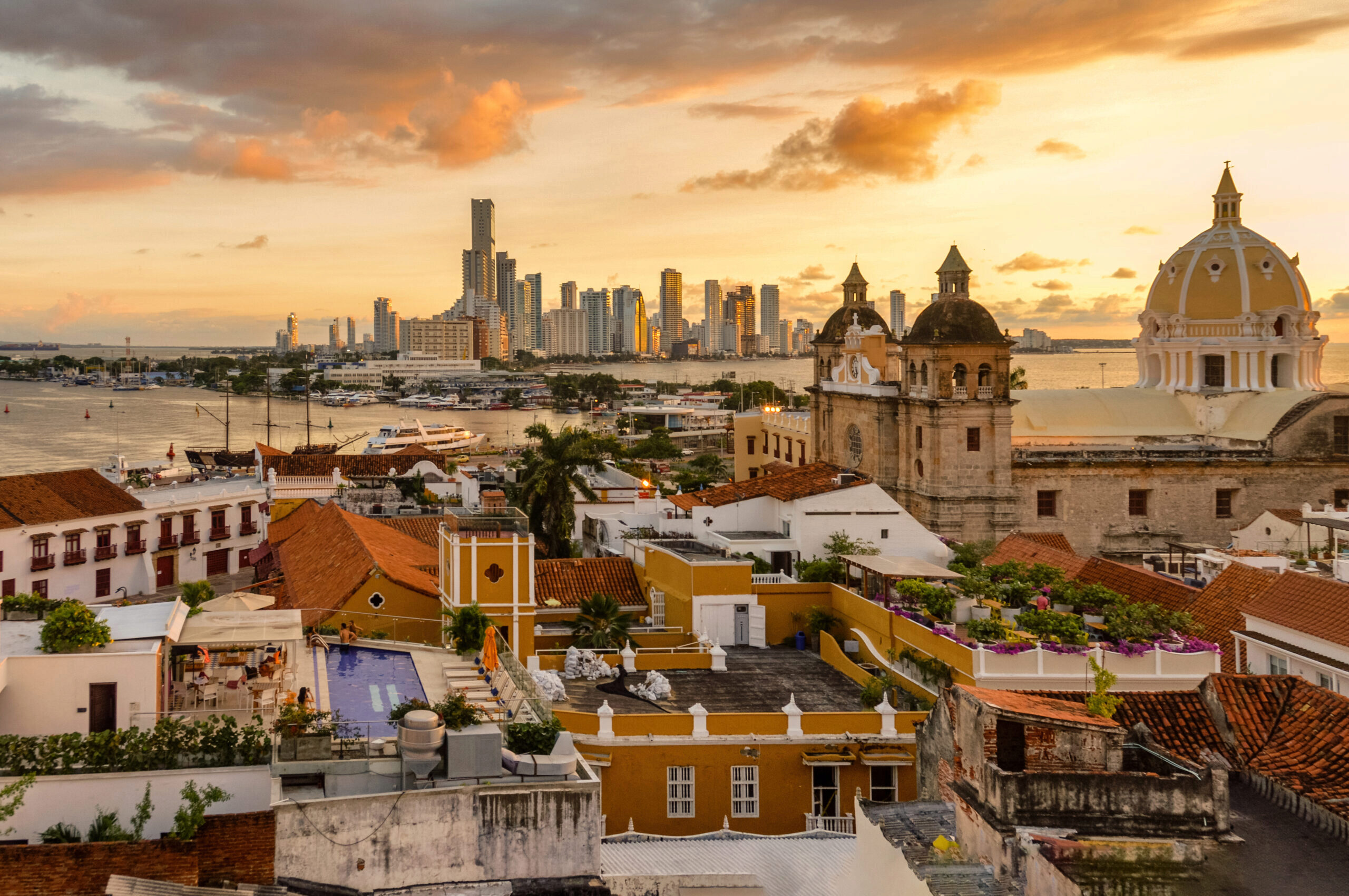 Cartagena Colombia Skyline At Sunset Decorative image of Cartagena Colombia Skyline At Sunset with old buildings and new buildings separated by a waterway