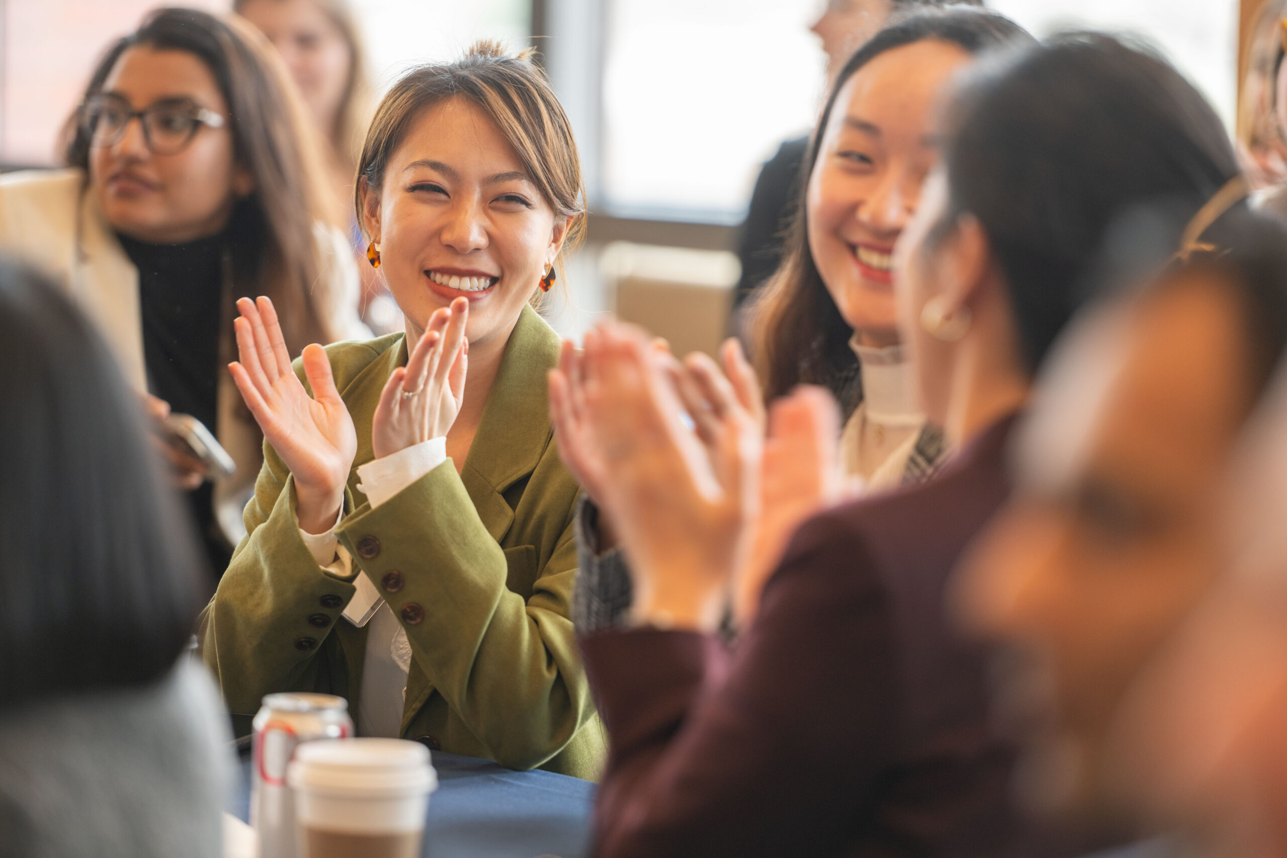 Students at a table clapping.
