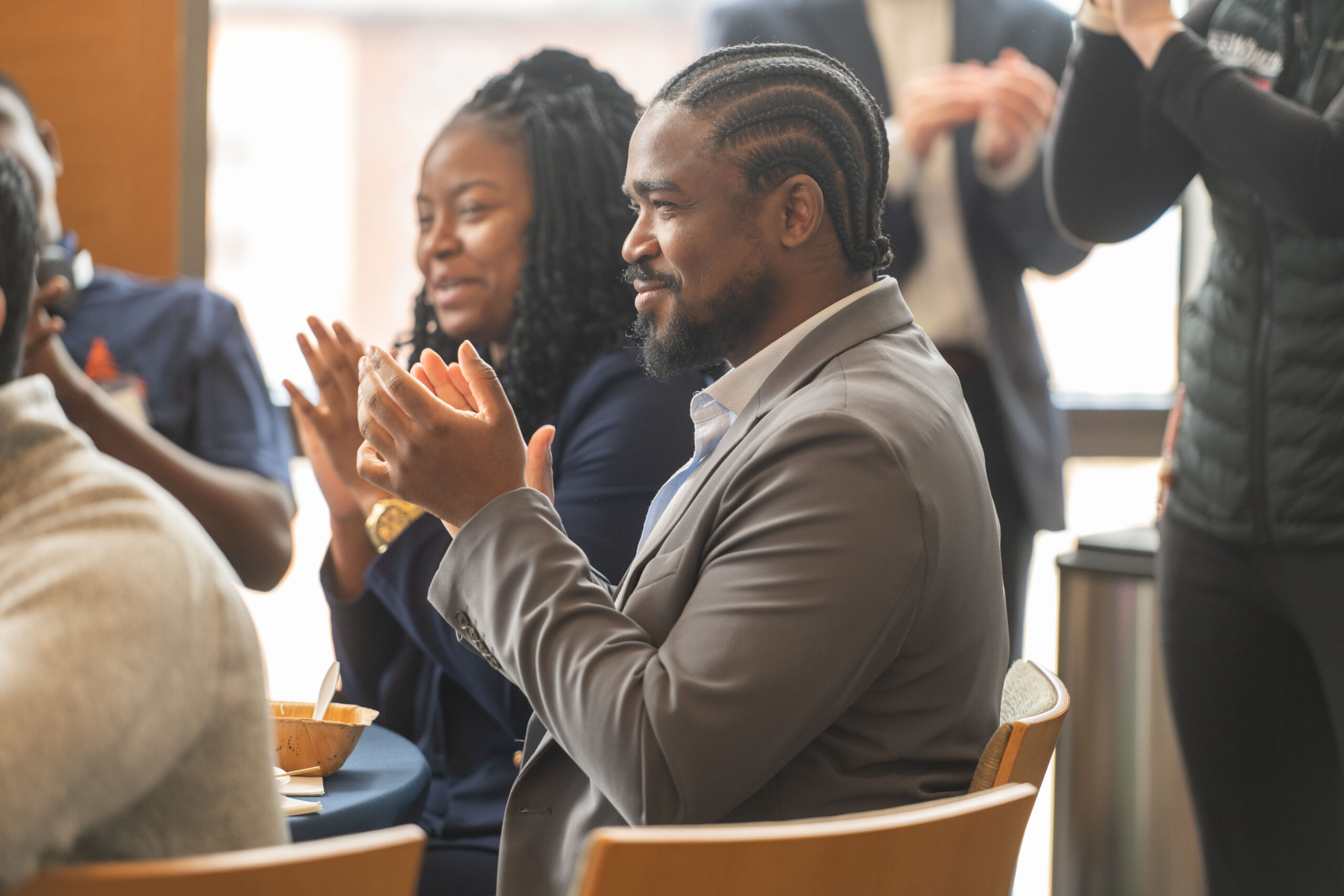 Students at a table clapping.