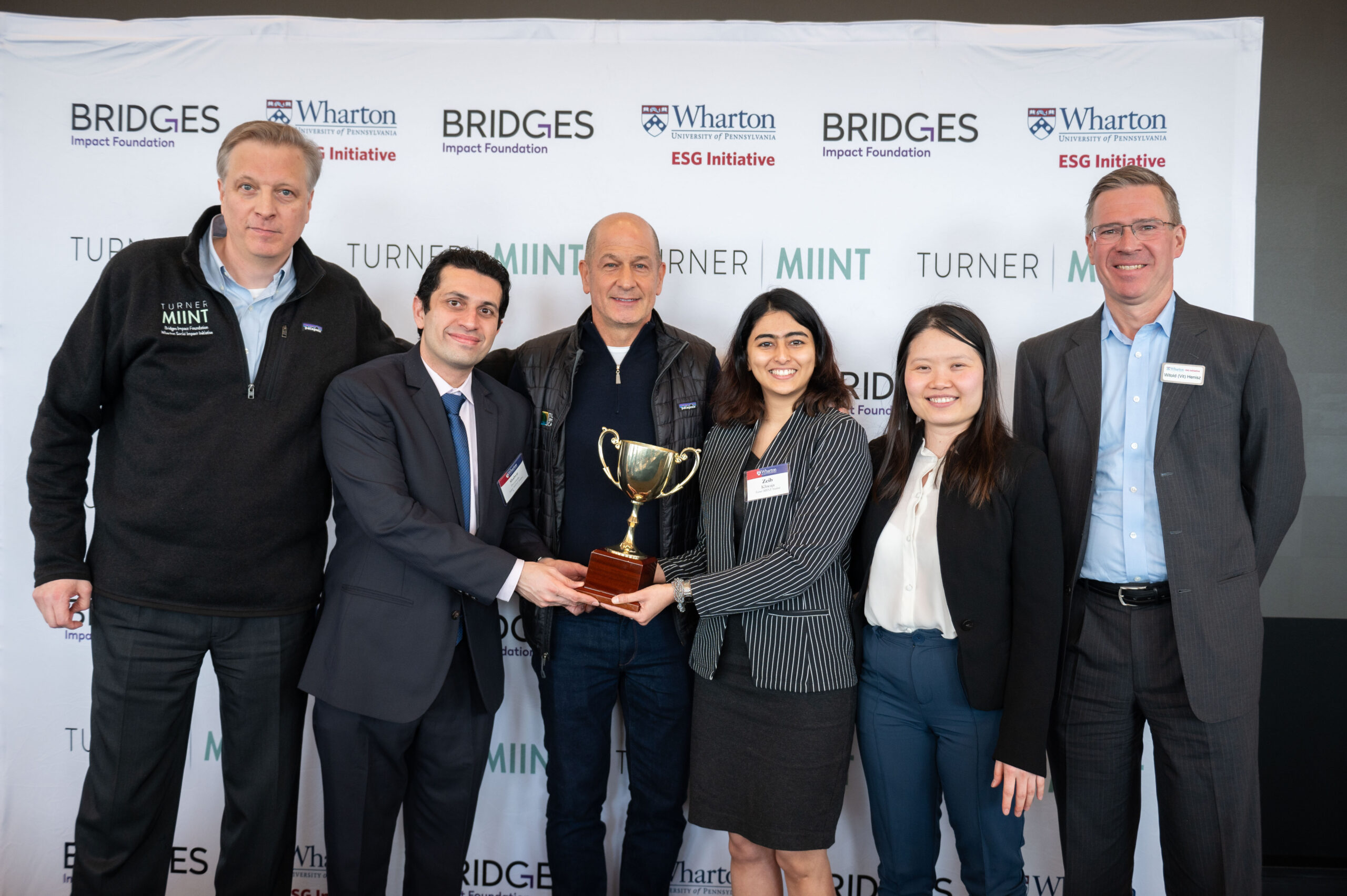 Winning Team TMIINT 2024 The London Business School team posed with the TMIINT trophy, Brian Trelstad, Bobby Turner, and Witold Henisz.
