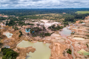 Aerial,View,Of,Deforested,Area,Of,The,Amazon,Rainforest,Caused Aeriel shot of deforested area with forest in the background on the horizon.