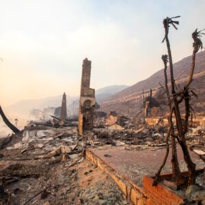 The,Palisades,Fire,Burns,Fiercely,During,A,Powerful,Windstorm,,Spreading Photos of the remains of a coastline and structures after a wildfire