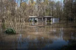 An aerial view shows floodwater surrounding a home on April 7, 2025, in Paducah, Kentucky.
