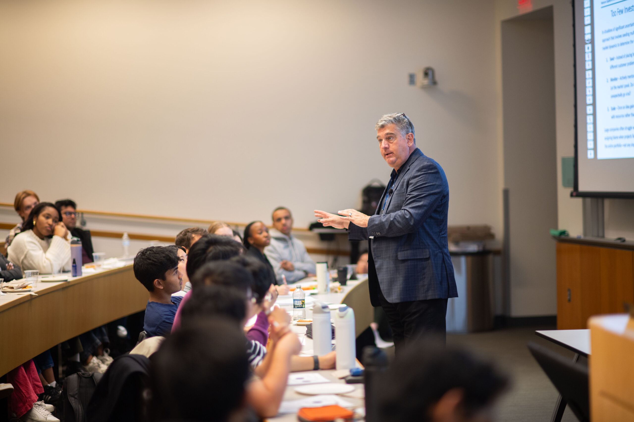 Prof. David Wessels standing at the front of a classroom talking to a class of students